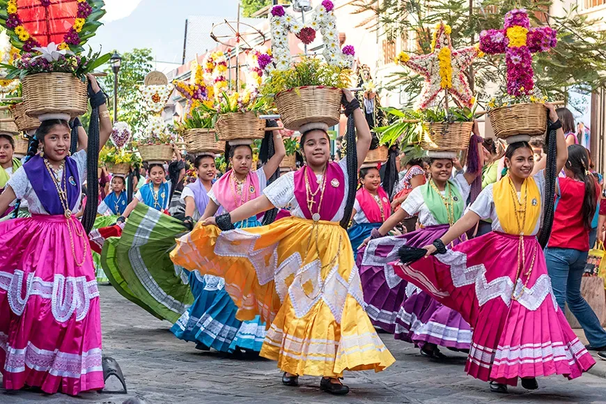 Girls dressed with traditional clothes during the Convite, a party made for invite to a big traditional party called Guelaguetza in Oaxaca, Mexico